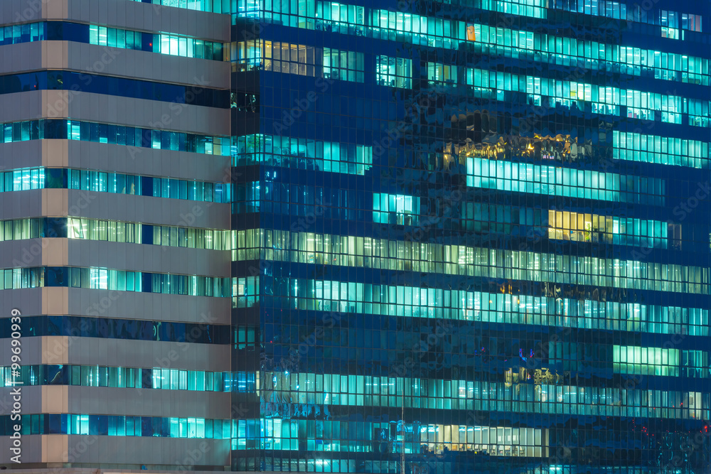 windows of office buildings illuminated at night for background windows of office buildings illuminated at night for background