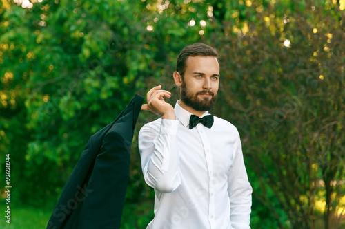 young bridegroom in a park in spring photo