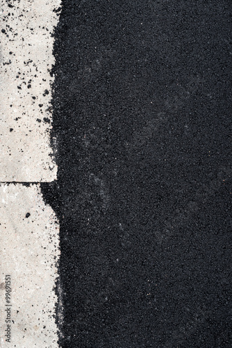 New asphalt concrete near the concrete kerb