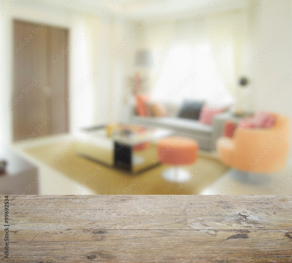 wooden table top with blur of modern living room interior with orange tone decoration wooden table top with blur of modern living room interior with orange tone decoration