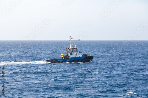 Blue Tugboat at Sea