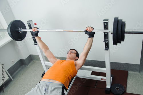 The guy doing bench press barbell