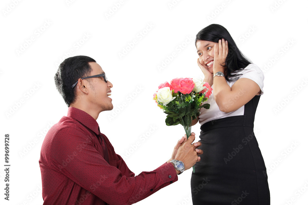 Man proposing with flowers, isolated on white