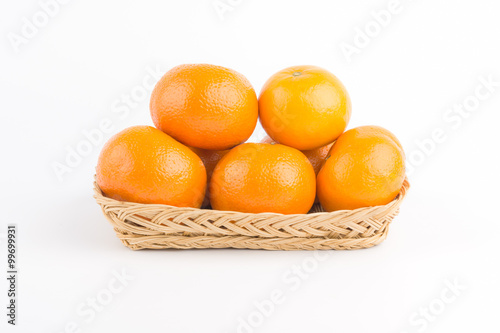 Orange ripe in basket on white background.