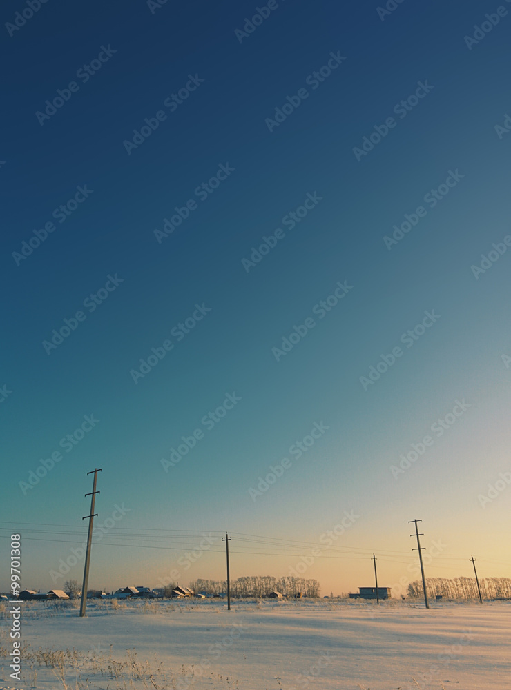Blue sunset sky under the snowy field