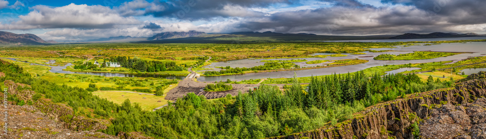 Panorama of green valley with the river and the mountains in Iceland