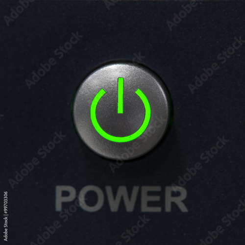 Power switch push button and green light power on symbol.
