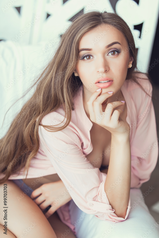 Beautiful alluring young woman in sexy lingerie at home