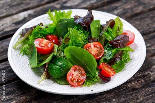 Fresh Green Vegetable mixed salad on wooden table