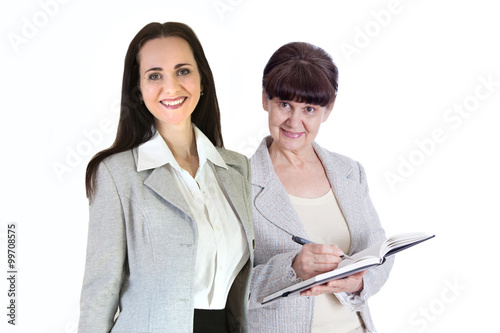 Successful business woman smiling portrait and her assistant with notepad and files. Portrait in office photo