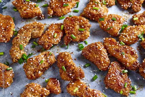 Chicken nuggets in sticky honey sauce. Top view