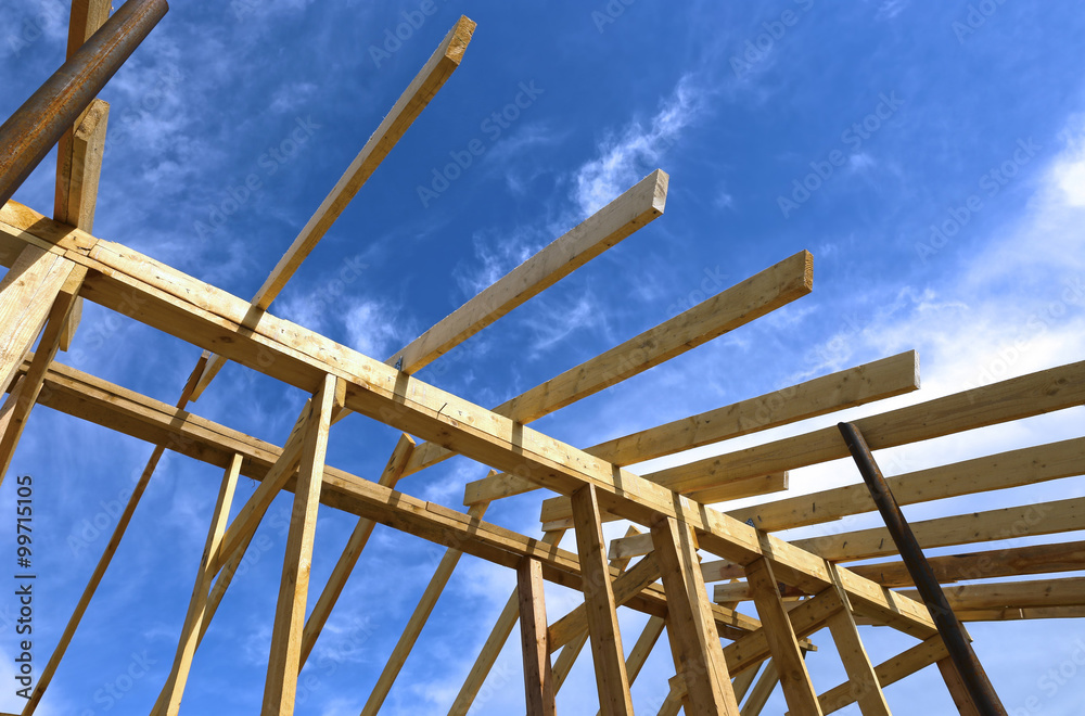 Installation of wooden beams at construction the roof Installation of wooden beams at construction the roof