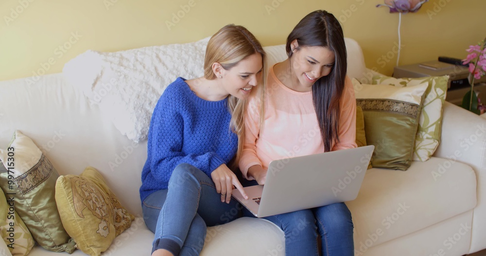 Two happy young women browsing the internet Two happy young women browsing the internet