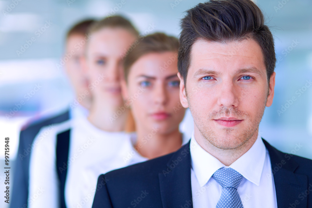 Smiling successful business team standing in office Smiling successful business team standing in office