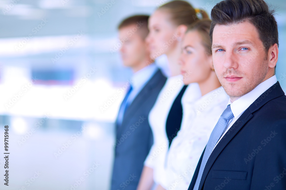 Smiling successful business team standing in office Smiling successful business team standing in office