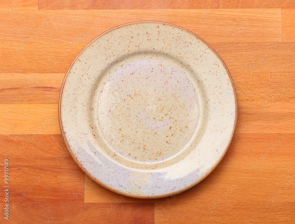 Empty plate on a wooden table. Background for your menu. Empty plate on a wooden table. Background for your menu.