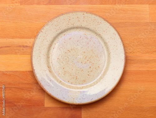Empty plate on a wooden table. Background for your menu.