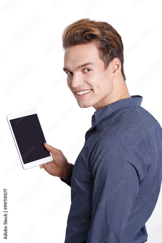 Young man Looking at a tablet, isolated in white Young man Looking at a tablet, isolated in white