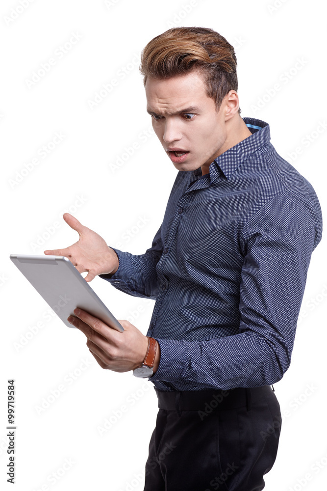 Young man Looking at a tablet, isolated in white Young man Looking at a tablet, isolated in white