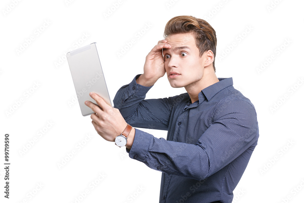 Young man Looking at a tablet, isolated in white Young man Looking at a tablet, isolated in white
