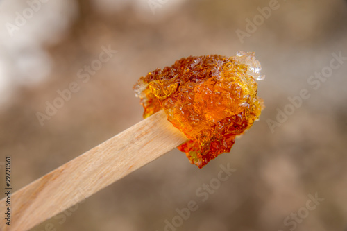 Maple taffy on a stick during sugar shack period photo