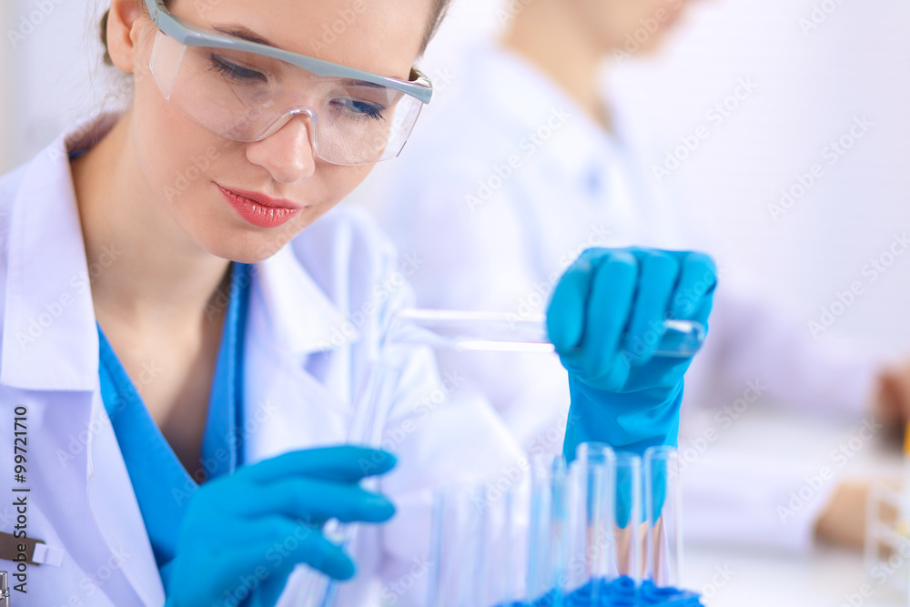 Fototapeta premium Woman researcher is surrounded by medical vials and flasks, isolated on white background