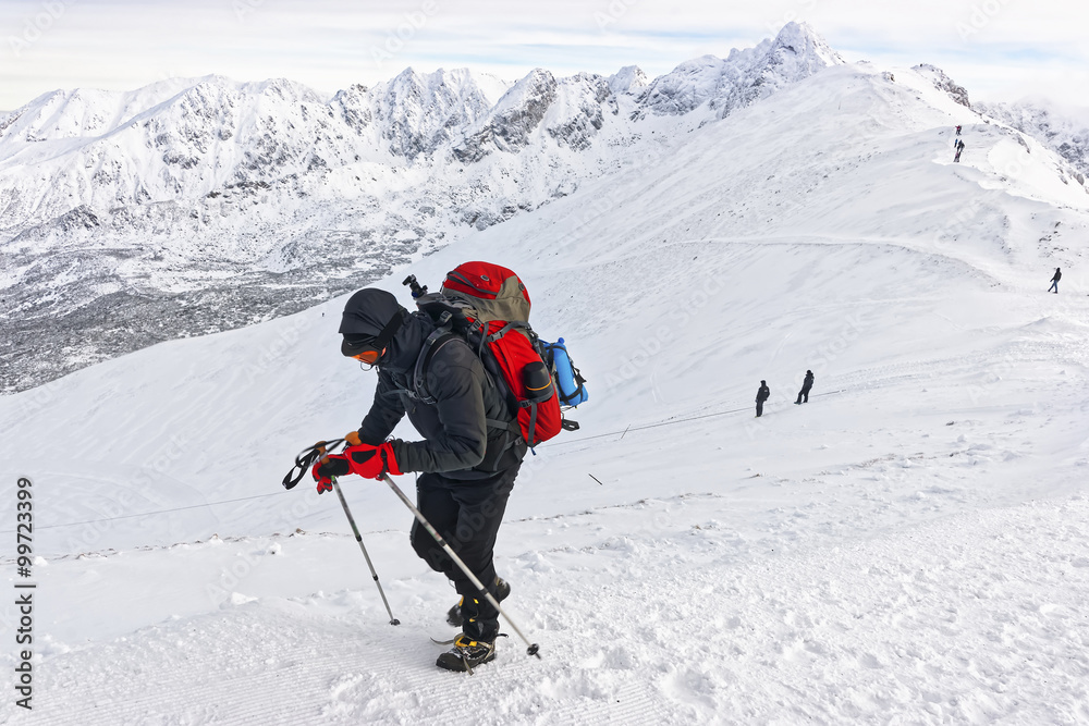 Man climbing on Kasprowy Wierch in Zakopane on Tatras in winter