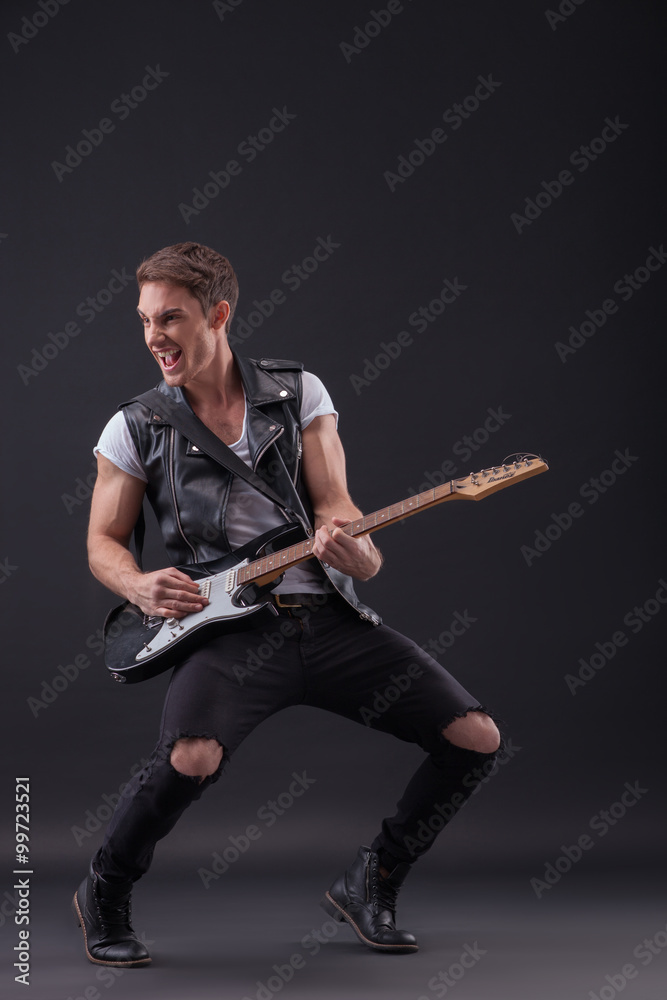 Fototapeta premium Skillful young musician is making great performance
