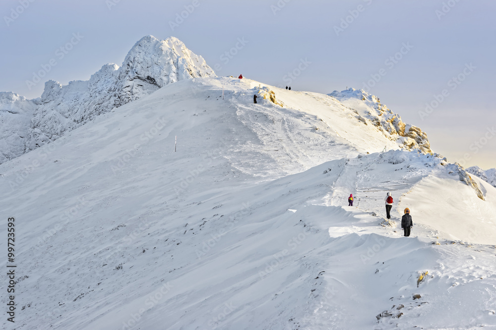 People climbing at the top of Kasprowy Wierch of Zakopane in winter
