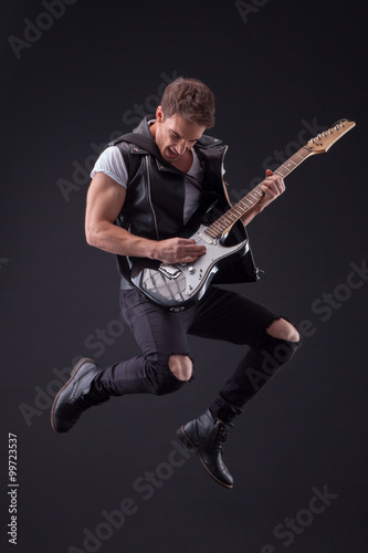 Attractive male guitarist with a cool musical instrument