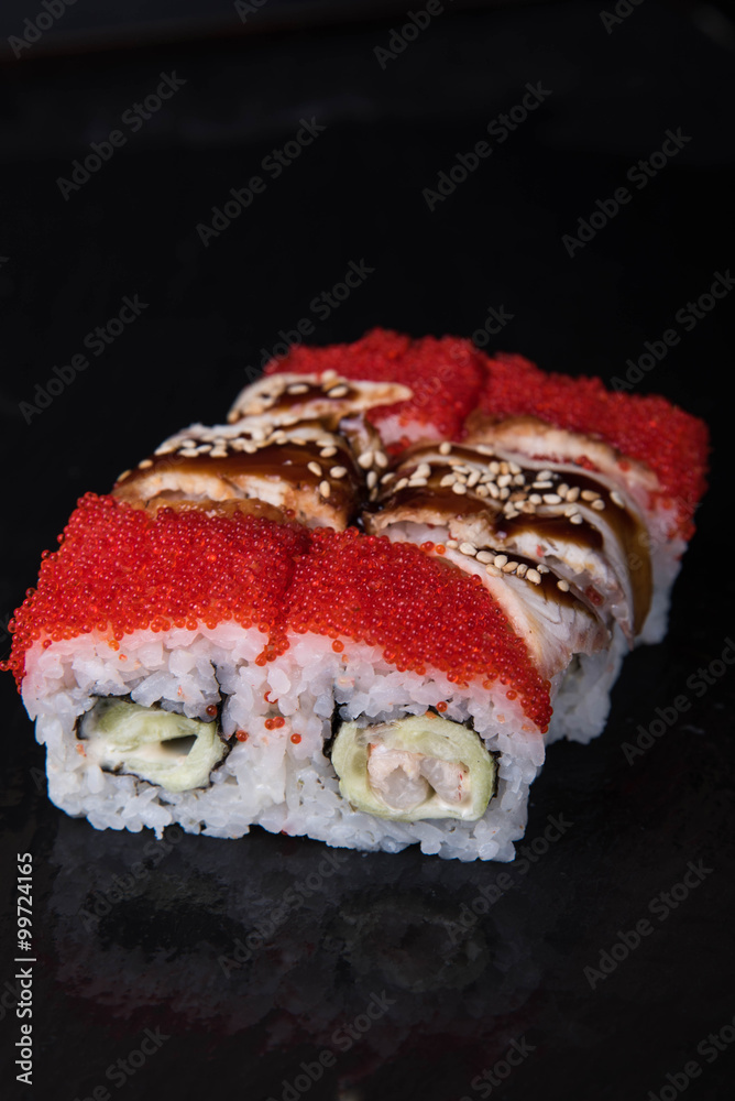 Sushi rolls on a black background, Japanese cuisine Sushi rolls on a black background, Japanese cuisine