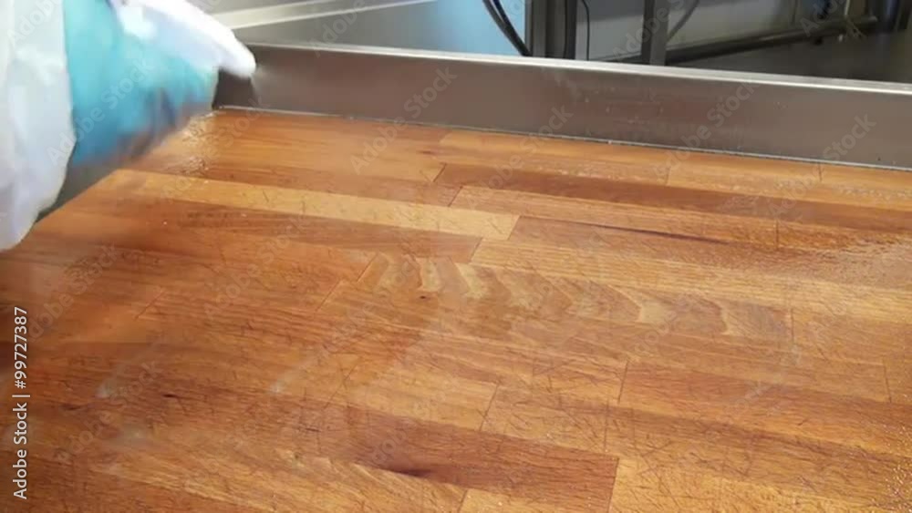 Clean surfaces and angles of a wooden table yellow brush. Cleaning of premises and equipment in the food industry, supermarkets, warehouses with food and other similar places. Clean surfaces and angles of a wooden table yellow brush. Cleaning of premises and equipment in the food industry, supermarkets, warehouses with food and other similar places.