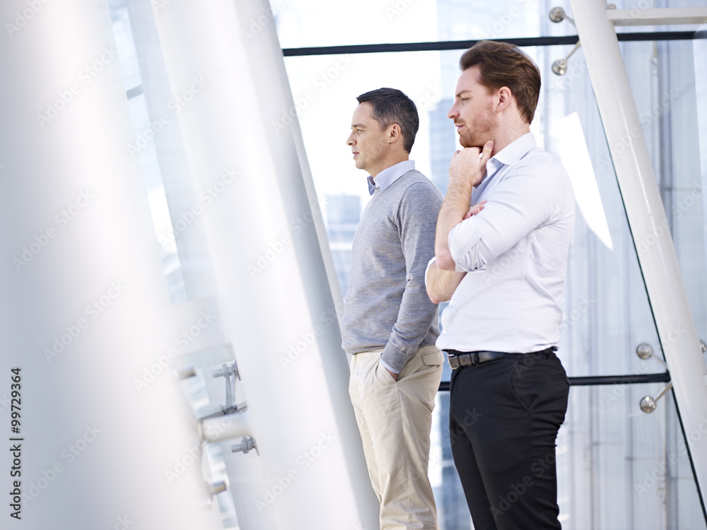 businessmen looking out of window