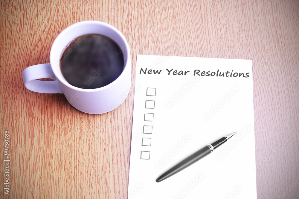 Coffee on the table with note writing new year resolutions Coffee on the table with note writing new year resolutions