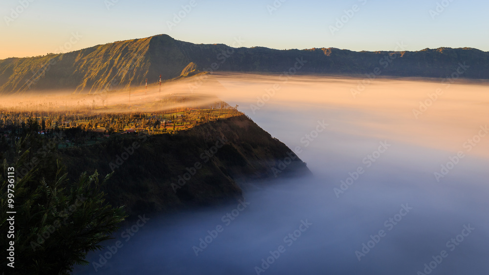 Morning Mist covers Cliff Village in Mount Bromo, Indonesia
