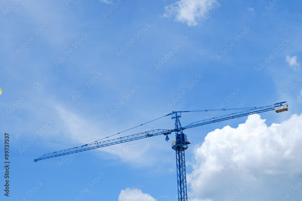 large construction crane machine with clear blue sky background