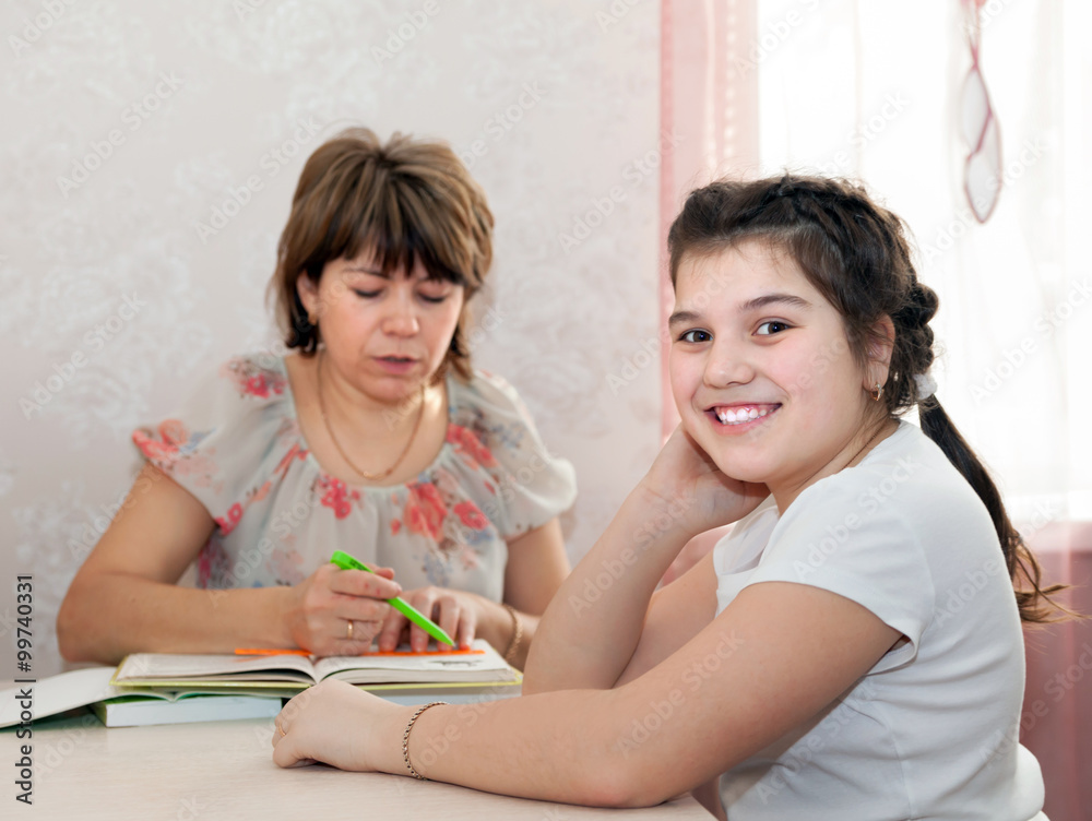 Mom and daughter doing homework at home. Mom and daughter doing homework at home.