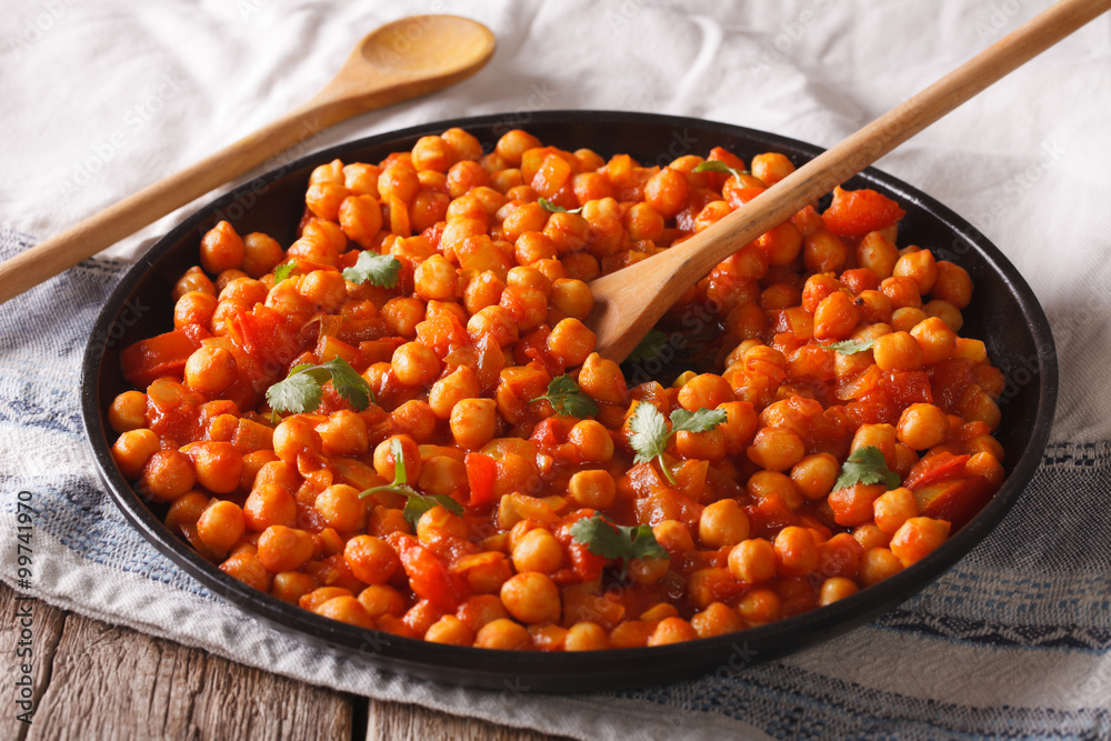 Indian Food: chickpeas in curry sauce close-up. Horizontal Stock Photo