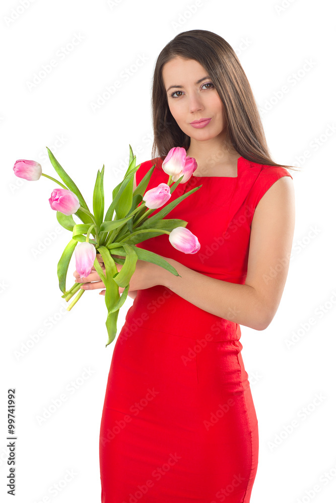 Pretty brunette caucasian woman holding pink tulips and wearing bright red dress. Pretty brunette caucasian woman holding pink tulips and wearing bright red dress.