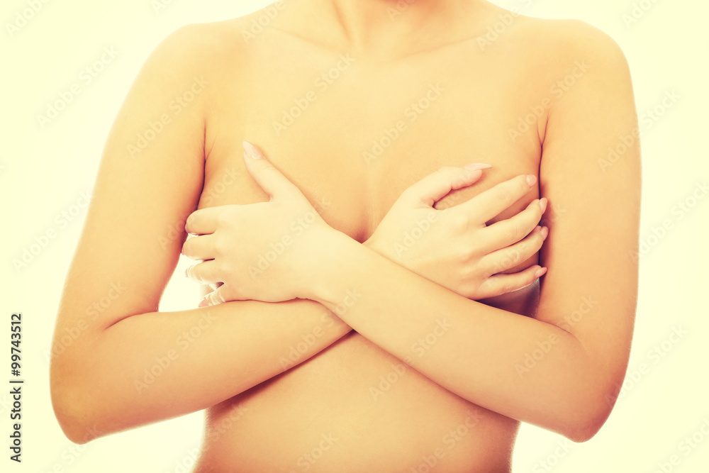 Woman covering her breast.