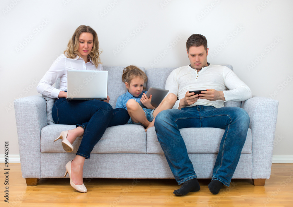 Modern family values. Father, mother and daughter using electronic devices. Modern family values. Father, mother and daughter using electronic devices.