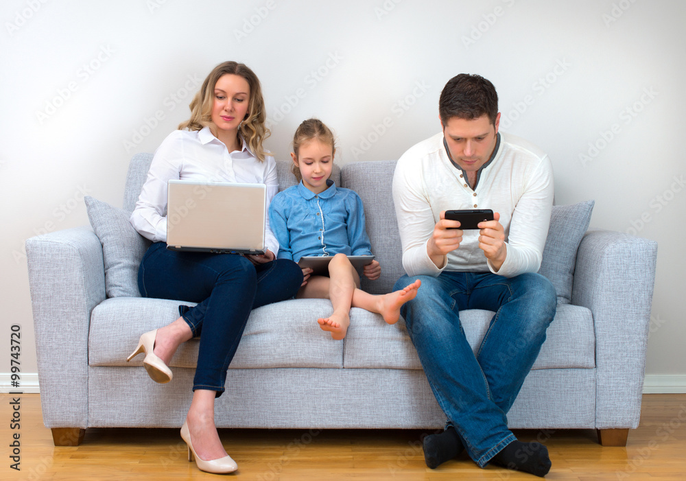Modern family values. Father, mother and daughter using electronic devices. Modern family values. Father, mother and daughter using electronic devices.