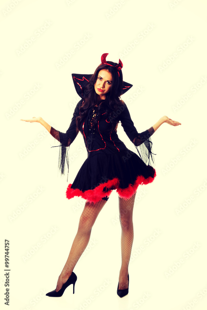 Woman in devil clothes with open hands gesture Woman in devil clothes with open hands gesture