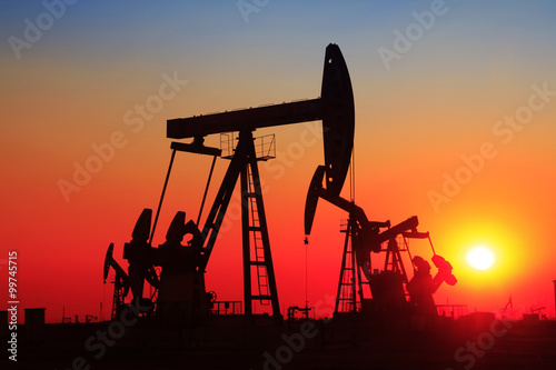 Oil field scene, the evening of beam pumping unit in silhouette
