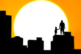 silhouette of father and son standing on the building sunset bac