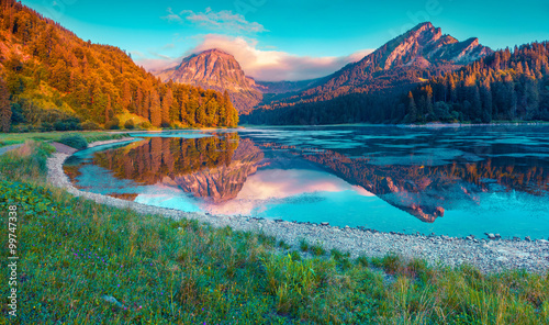 Colorful summer sunrise on the incredibly beautiful Swiss lake O photo