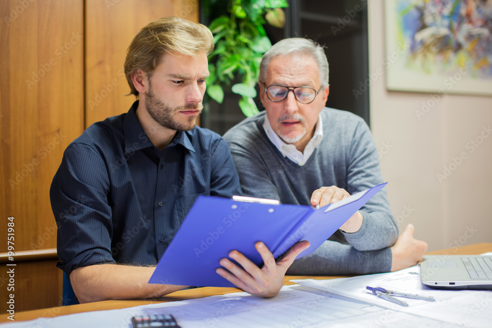 Businessman showing a document to his colleague Businessman showing a document to his colleague