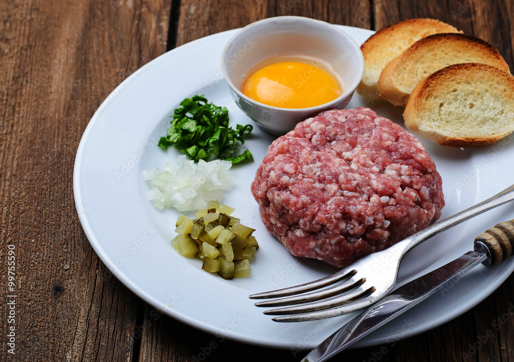 Fresh beef tartar with egg, pickled cucumber and onion. Fresh beef tartar with egg, pickled cucumber and onion.