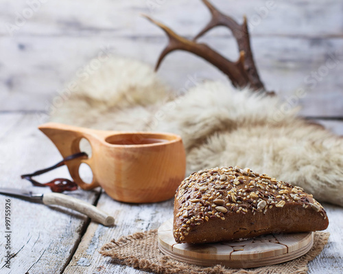 Rue bun with seeds and finnish cup kuksa photo