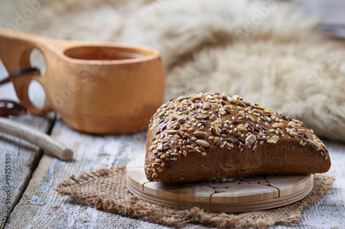 Rue bun with seeds and finnish cup kuksa photo